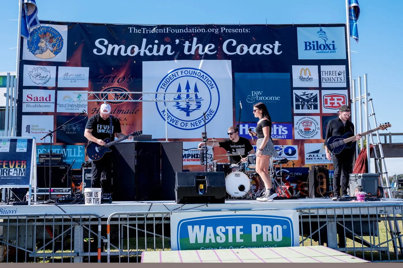 Live band performing on stage at the Smokin' the Coast BBQ competition